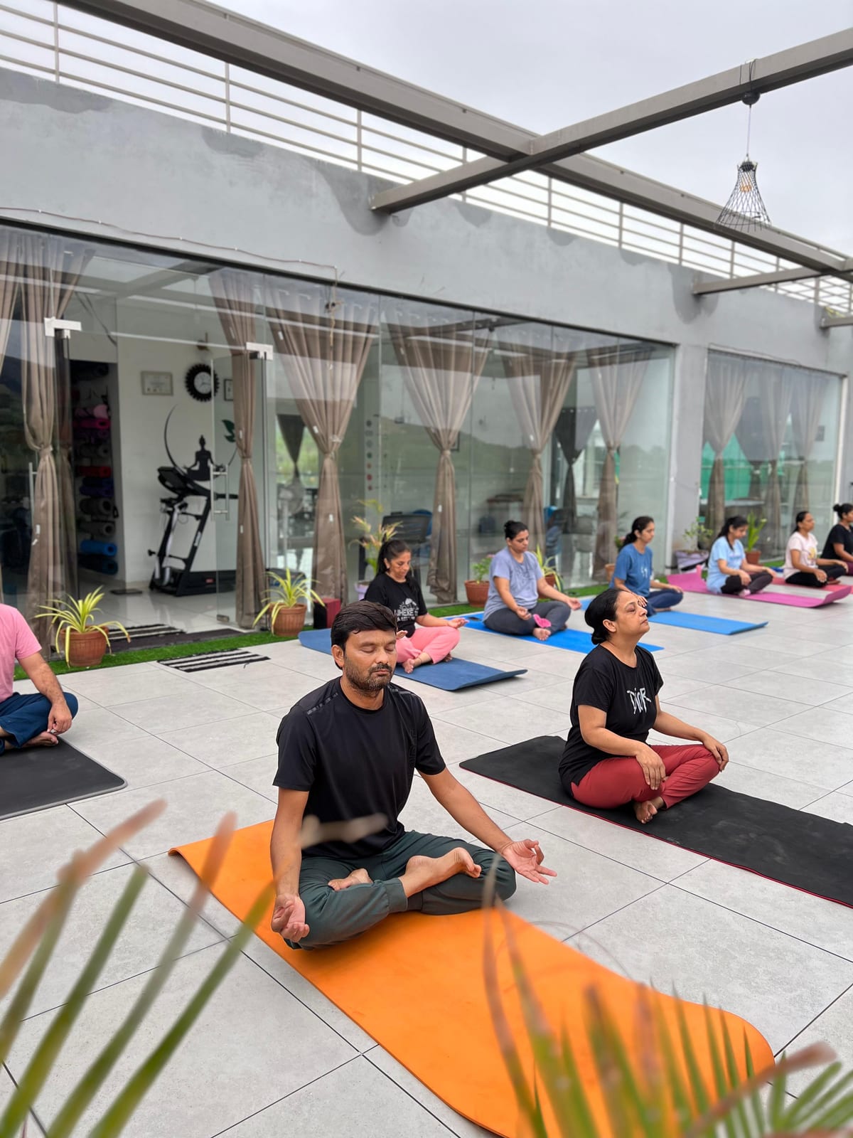 Students in seated meditation on the outdoor rooftop terrace
